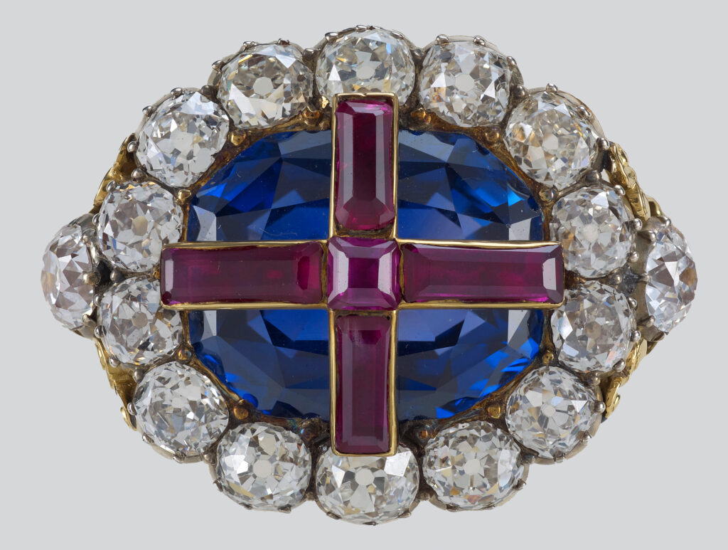 The Sovereign's Ring is set in the with a thin ruby at its centre, engraved with the cross of St George with foil behind